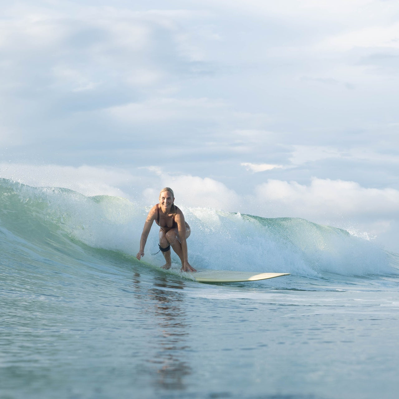 From ocean to land—Tumla’s active swimwear is made for movement, showcased here by two women embracing the wild coast.