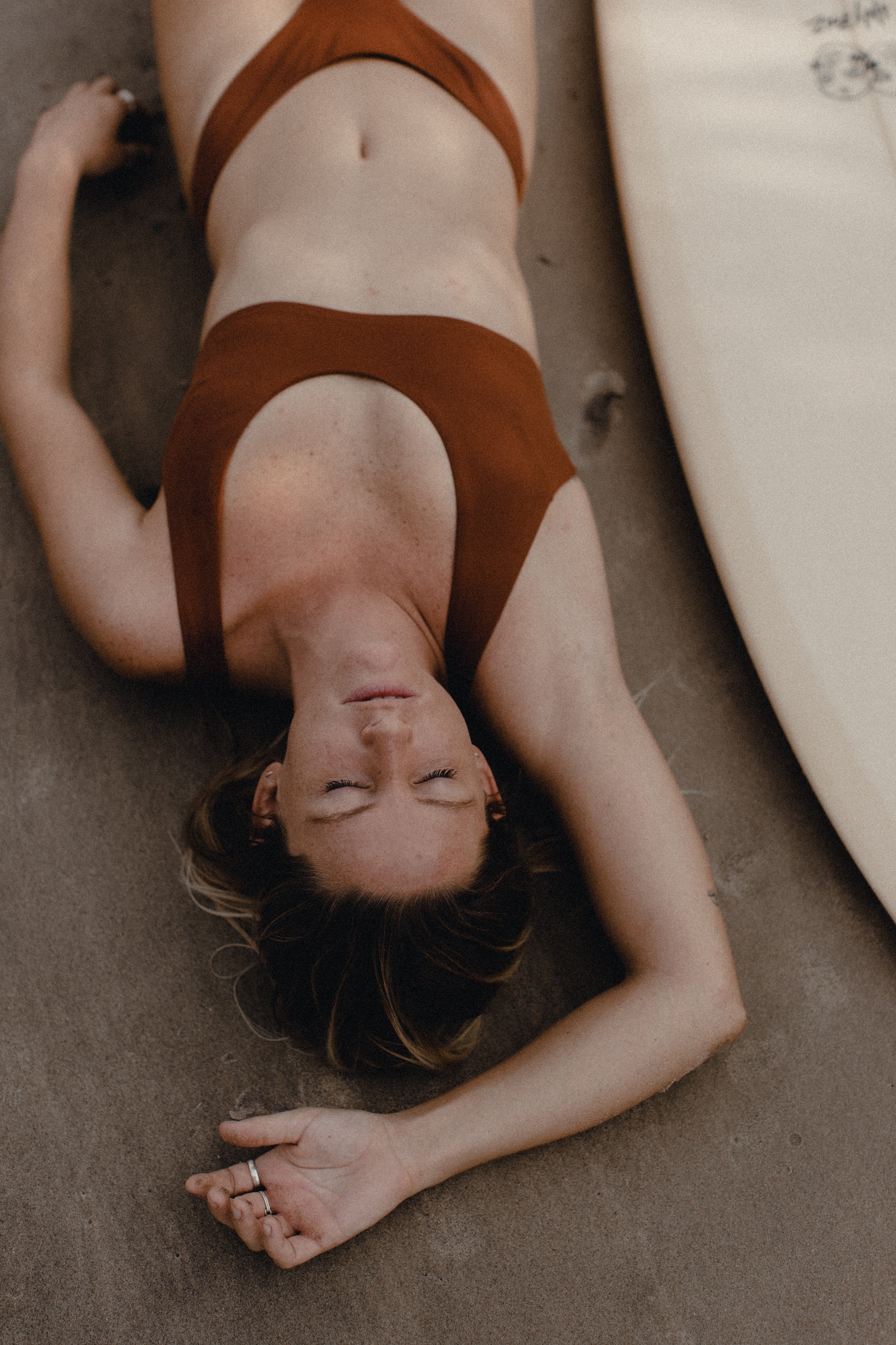 Vibrant and versatile—Tumla’s burnt orange bikini, worn by a blonde, offers a stylish fit that moves with you throughout the day