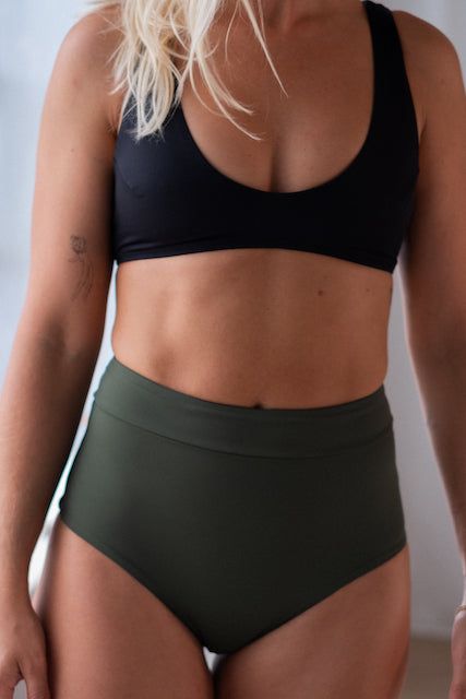 Classic black bikini by Tumla, worn by a blonde, offering both comfort and support for surfing and other water sports