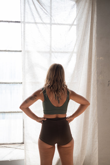 Sporty green bikini from Tumla, worn by a brunette, offering the perfect fit and flexibility for active surfers