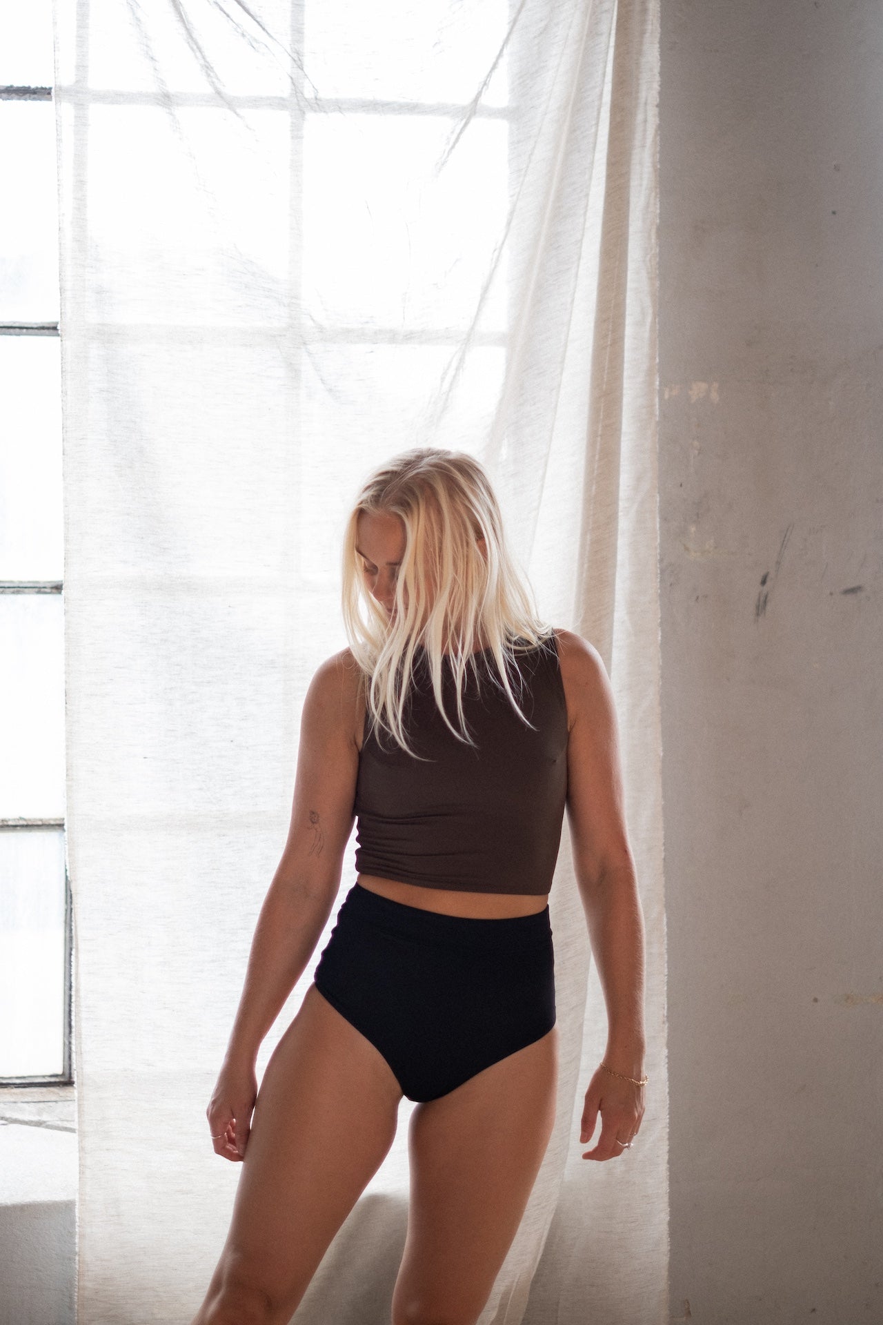 Performance-driven—Tumla’s brown bikini, worn by a blonde woman, offers durability and comfort for every move.