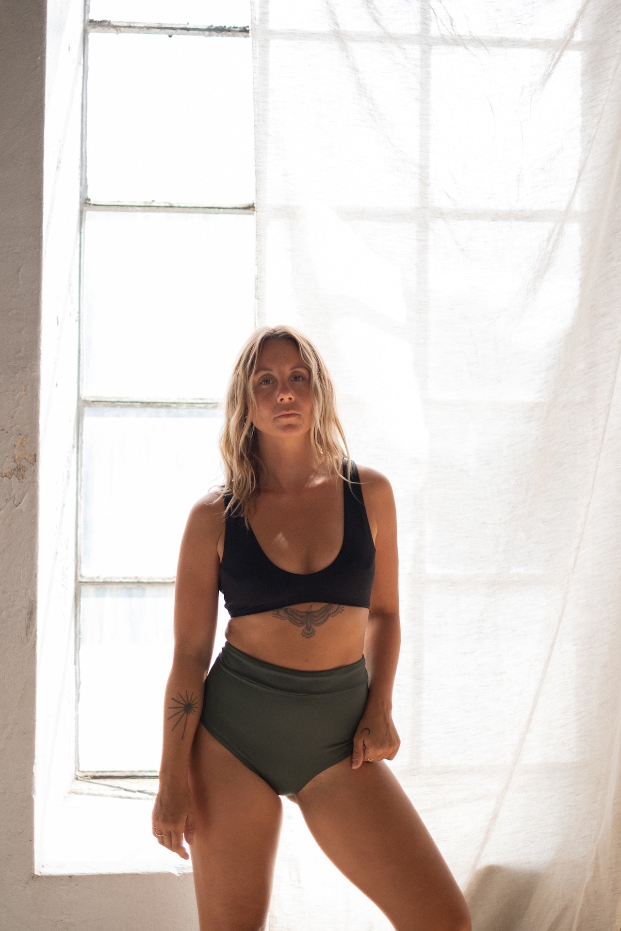 Supportive and stylish—Tumla’s green bikini, worn by a brunette woman, delivers flexibility and functionality with a modern twist.